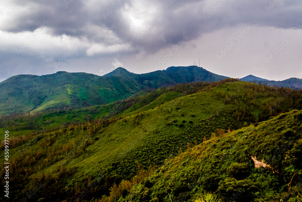 green mountains in rainny day of summer, gray clouds in the sky, sierra de guadalupe state of mexico and mexico city 