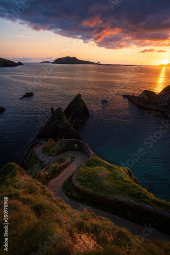 Rocks at Sea • Dunquin Pier, the wild link to Great Blasket Island, is watching a calm and quiet sunset. photo