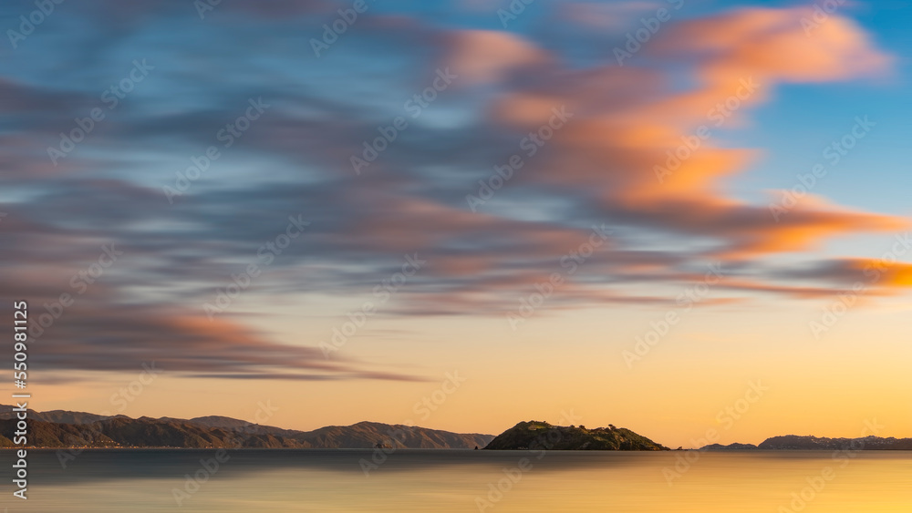 Beautiful Sunset over Wellington Harbour New Zealand with reflections of Matiu Somes Island in the water
