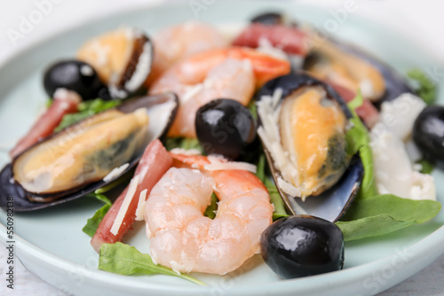 Plate of delicious salad with seafood, closeup view