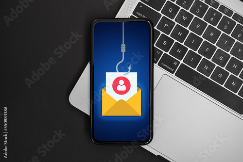 Phishing bait alert concept on a smartphone screen over a keyboard