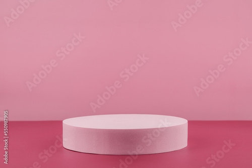 Podium pedestal showcase for cosmetic product presentation, minimal abstract pink background for cosmetics perfume and jewellery minimalist display. Empty stage for beauty products. Front view