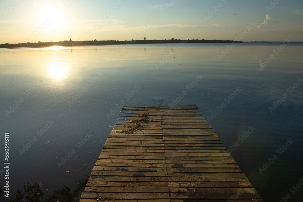 Wooden pier at sunset on a lake in Bueng Kan, Thailand 2022   