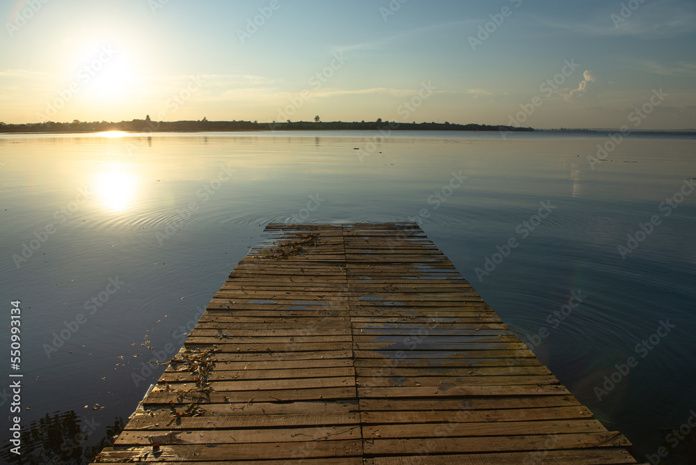 Wooden pier at sunset on a lake in Bueng Kan, Thailand 2022   