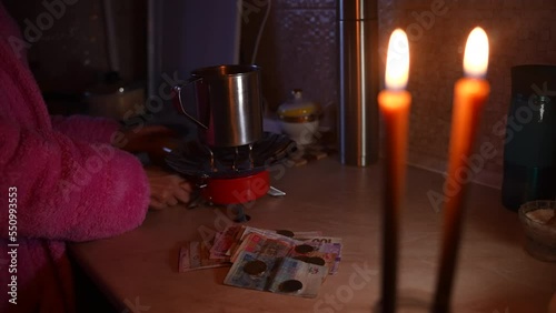 Wallpaper Mural The girl counts money by candlelight. Ukraine without electricity Torontodigital.ca