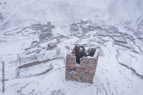Drone view of Galiat village at winter snowfall. Mountain Digoria  North Ossetia  Russia.