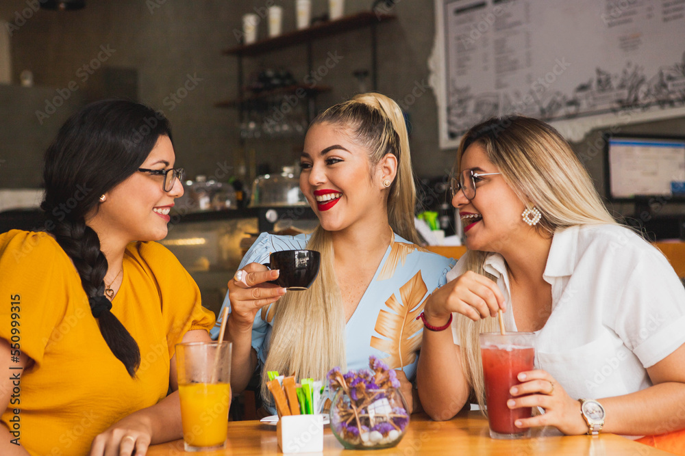 Three friends smiling while having a coffee in a bar Three friends smiling while having a coffee in a bar