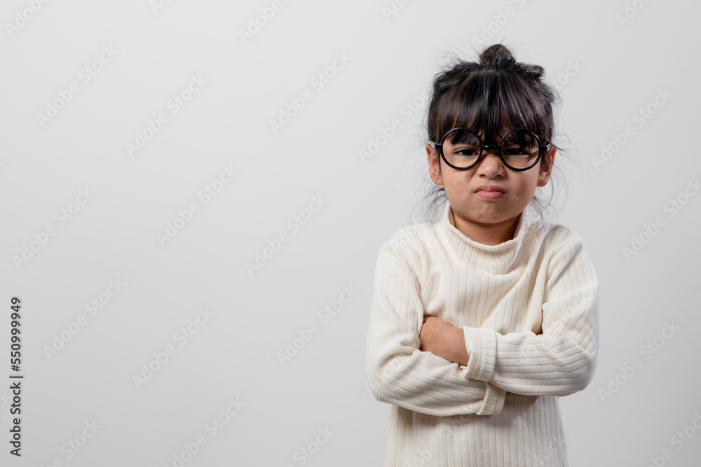 Angry little girl over white background, sign and gesture concept Angry little girl over white background, sign and gesture concept