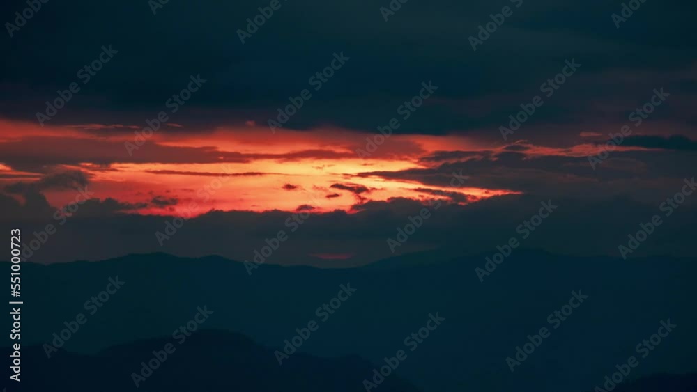 Time lapse of the beautiful sunset scenery on the top of the mountain. Aerial view of beautiful tropical valley silhouettes with the last rays of the sun. Dramatic sundown landscape.