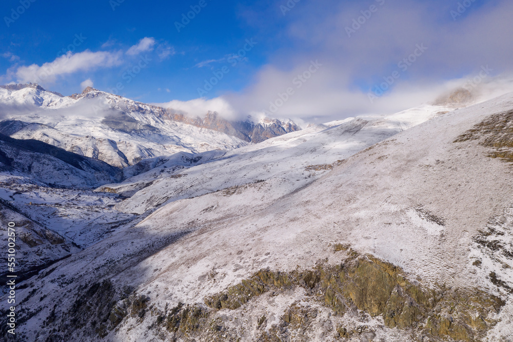 Caucasian landscape. Aerial view of Urukh river valley on sunny winter day. Digoria, North Ossetia, Russia.