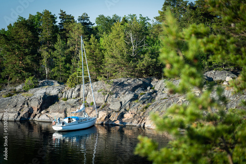 Sailboat anchored near remote rocky island in Stockholm archipelago, Sweden