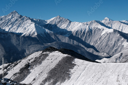 Caucasian winter landscape. View from Tsey Loam pass on sunny day. Ingushetia, Caucasus, Russia.