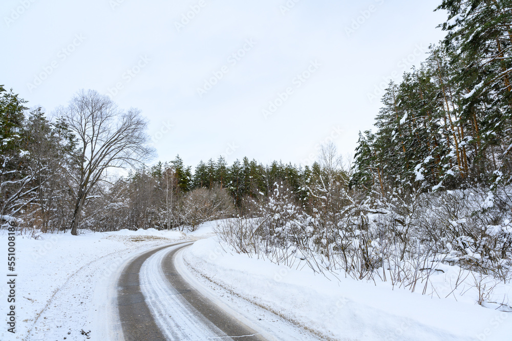 Snowy winter road in a mountain forest. Snowy winter road in a mountain forest.