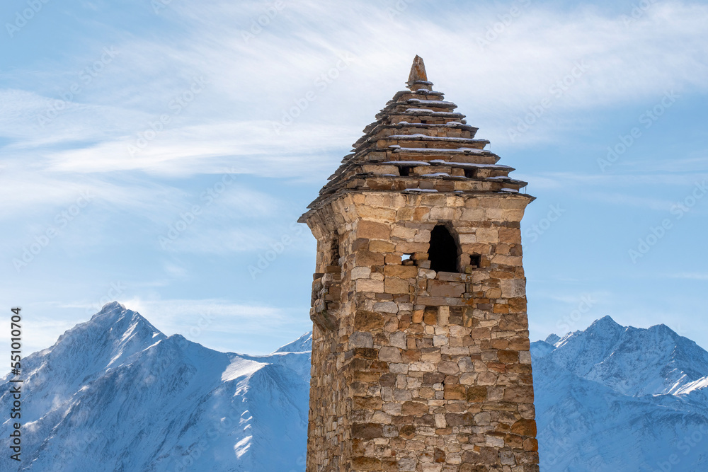 Upper part of medieval Ingush tower on sunny winter day. Niy, Ingushetia, Russia.