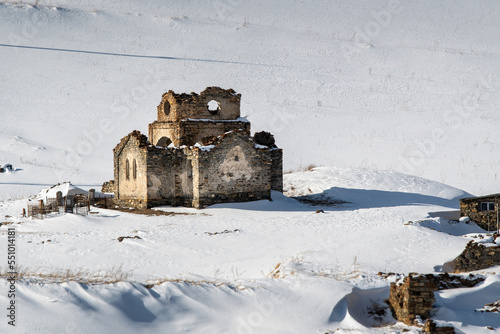 Remains of Uspenskaya church in Lisri village on sunny winter day. North Ossetia, Russia. photo