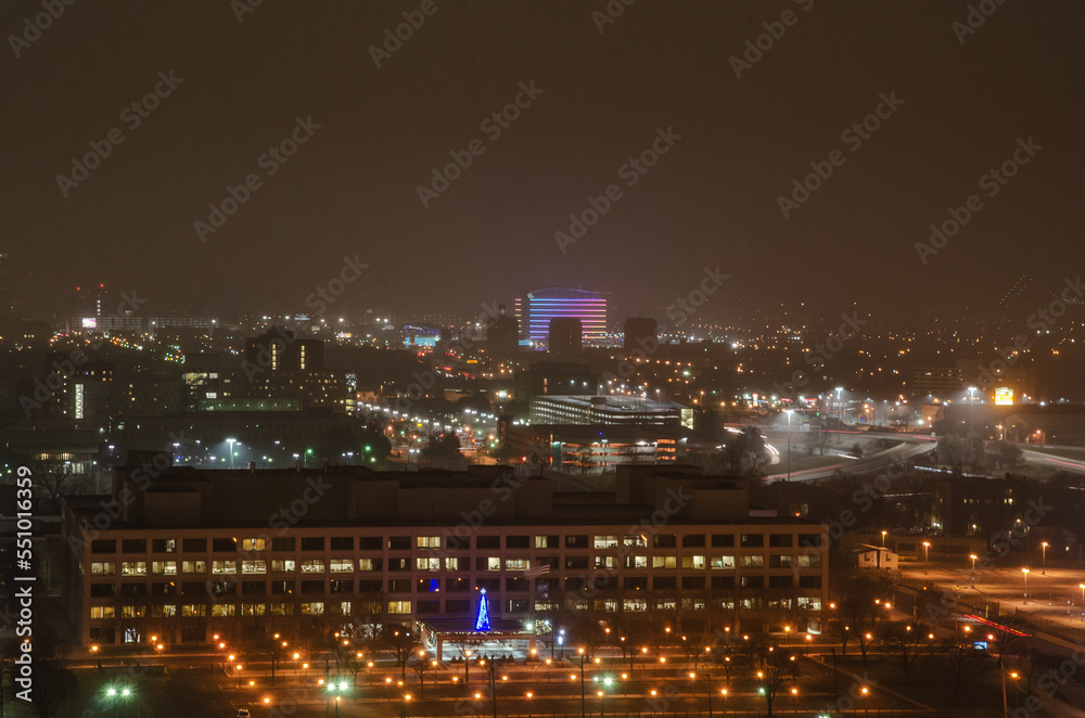 View of Downtown Detroit from the Fisher Building at night on a cloudy day.