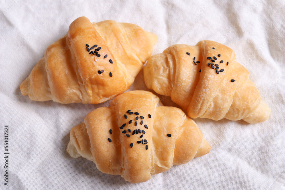 Top view of freshly made croissants laid on whites.