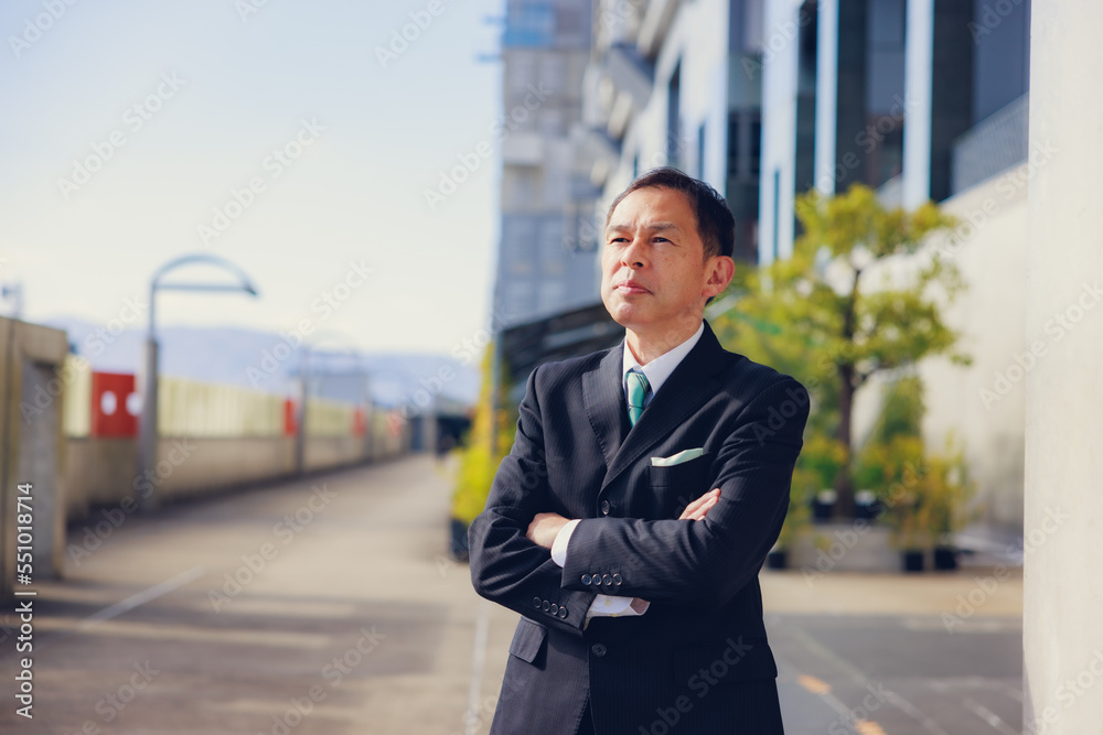 Middle-aged Asian man in black business suit at Kyoto station, Japan. Middle-aged Asian man in black business suit at Kyoto station, Japan.