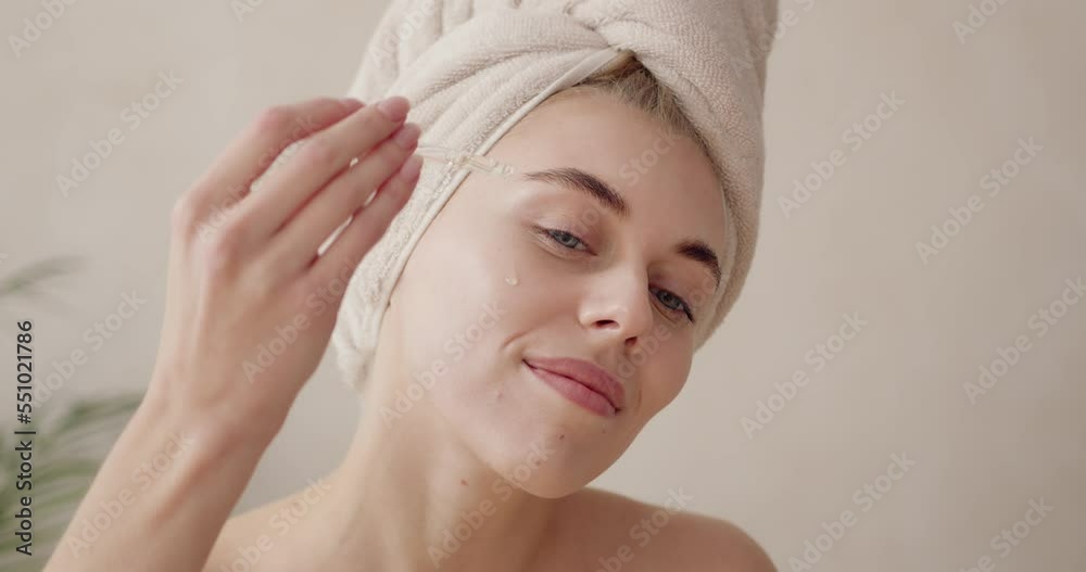 Woman dropping serum on face. European girl applying serum collagen moisturizer Woman dropping serum on face. European girl applying serum collagen moisturizer