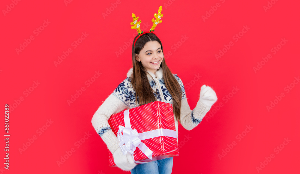 christmas holiday. glad teen girl with christmas present in deer antlers. teen girl christmas holiday. glad teen girl with christmas present in deer antlers. teen girl