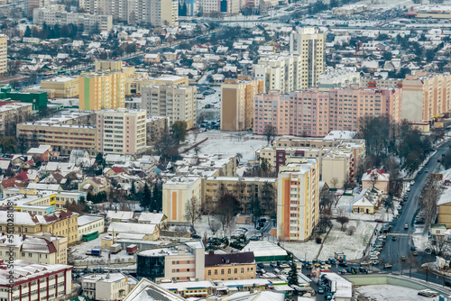 winter panoramic aerial view of a huge residential complex with high-rise buildings with snow