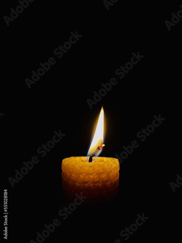 Candle on a black background. Candle flame.