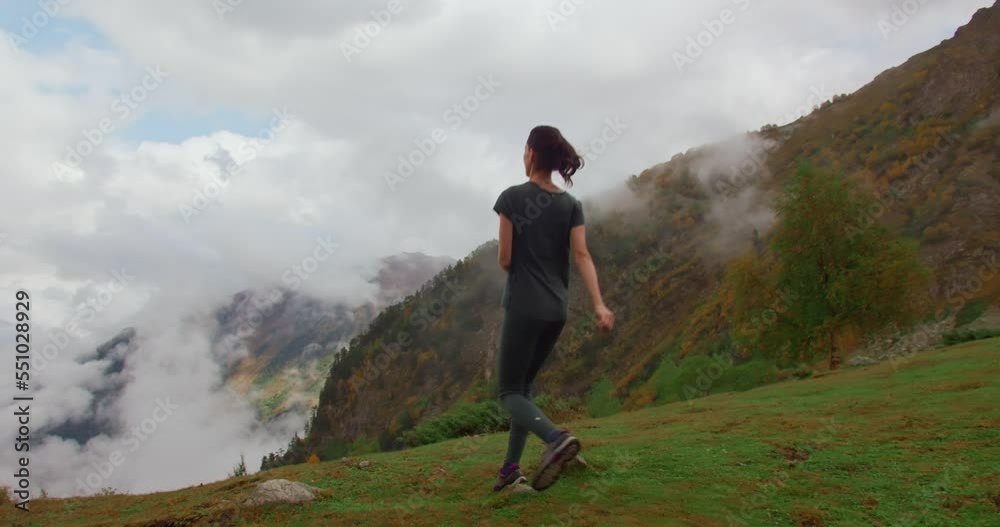 Hiker put off backpack and running with raises arms on top of mountain. nature travel a adventure concept Hiker put off backpack and running with raises arms on top of mountain. nature travel a adventure concept