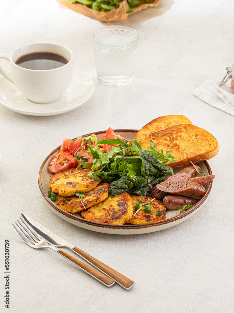 Portion of breakfast with potato pancakes and hunter's sausages Portion of breakfast with potato pancakes and hunter's sausages