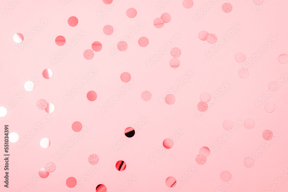 Confetti on pink background. New Year and Christmas celebration, holiday concept. Top view