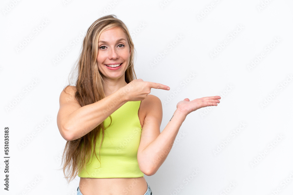 Young caucasian woman isolated on white background holding copyspace imaginary on the palm to insert an ad Young caucasian woman isolated on white background holding copyspace imaginary on the palm to insert an ad