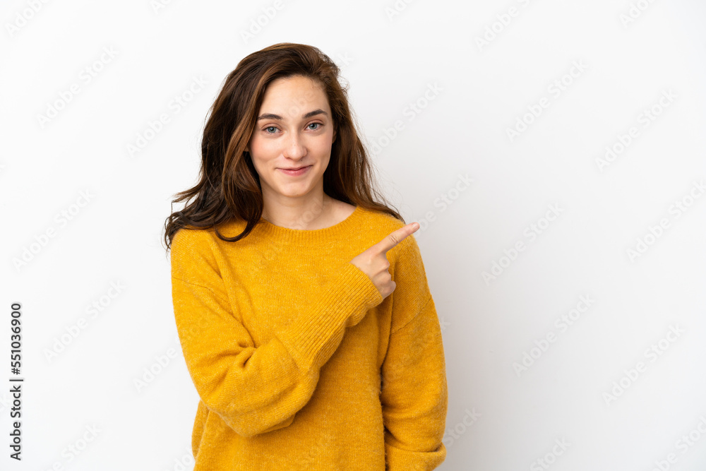 Young caucasian woman isolated on white background pointing to the side to present a product Young caucasian woman isolated on white background pointing to the side to present a product