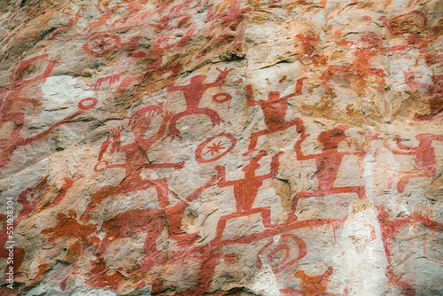 Ancestral Aboriginal rock art: spirit usually invisible to the humans-elongated fragile dancing figure in red ochre animal blood and fat, Guangxi, China photo