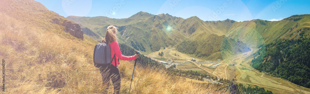Woman hiking zith backpack on the mountain- France, Auvergne, puy de Sancy