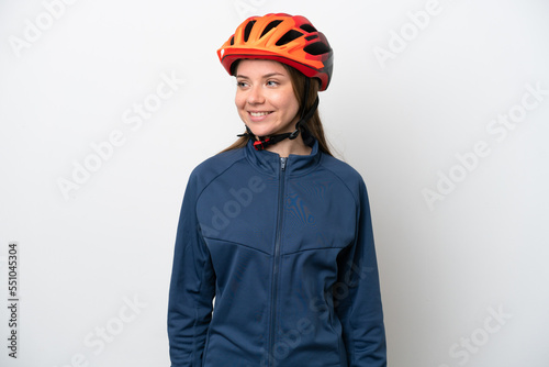 Young cyclist Lithuanian woman isolated on white background looking to the side and smiling © luismolinero