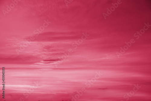 Trendy color of the year 2023. Sky with rain clouds toned in viva magenta color.sky abstract background, beautiful cloudscape, on the heaven, view over white fluffy clouds, freedom concept
