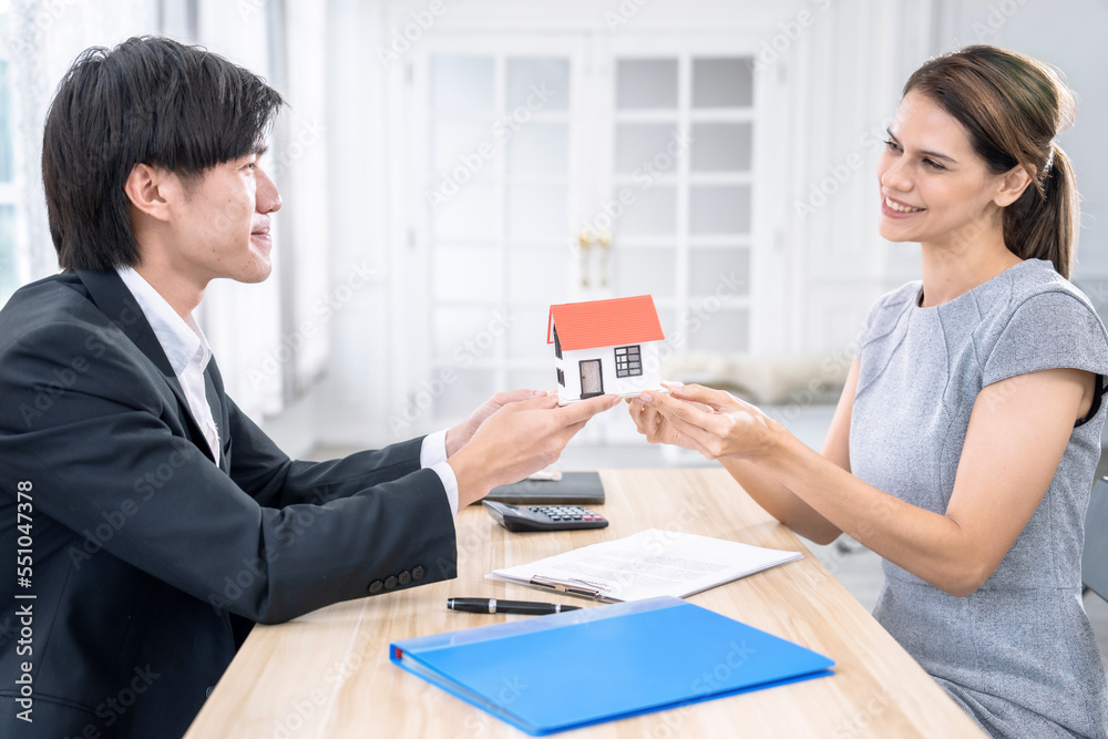 Real estate agents send clients models of houses and house keys, Making insurance or signing a real estate loan purchase agreement. Real estate agents send clients models of houses and house keys, Making insurance or signing a real estate loan purchase agreement.