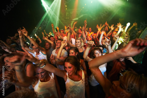 Party, music and dance with crowd at concert for rock, festival and live band performance. Light, laser and energy with audience listening to dj at club for disco, celebration and rave night event