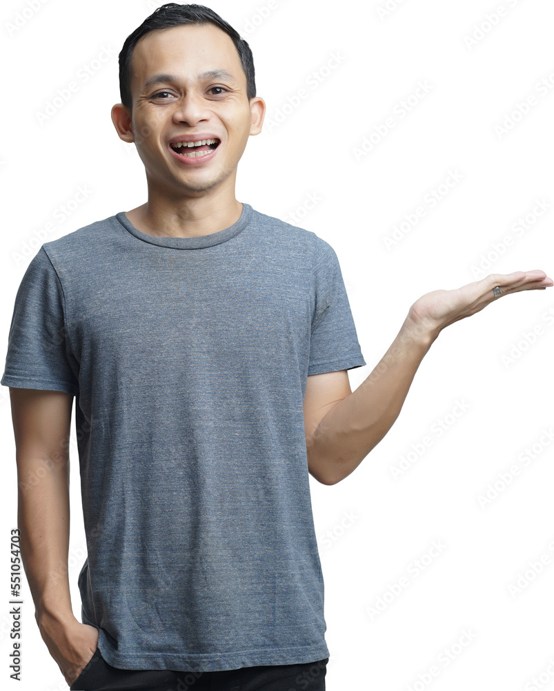 Attractive Asian man smiling while pointing to his open hand palm Attractive Asian man smiling while pointing to his open hand palm