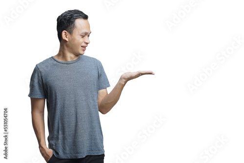 Attractive Asian man smiling while pointing to his open hand palm