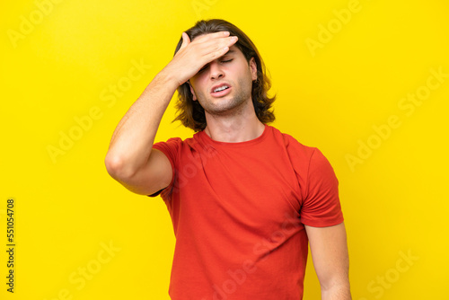 Caucasian handsome man isolated on yellow background with tired and sick expression © luismolinero