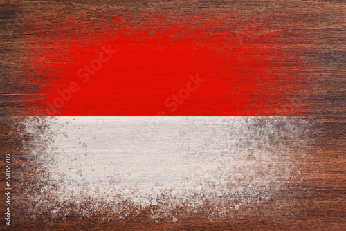 Flag of Monaco. Flag is painted on a wooden surface. Wooden background. Plywood surface. Copy space. Textured background © Alex Puhovoy