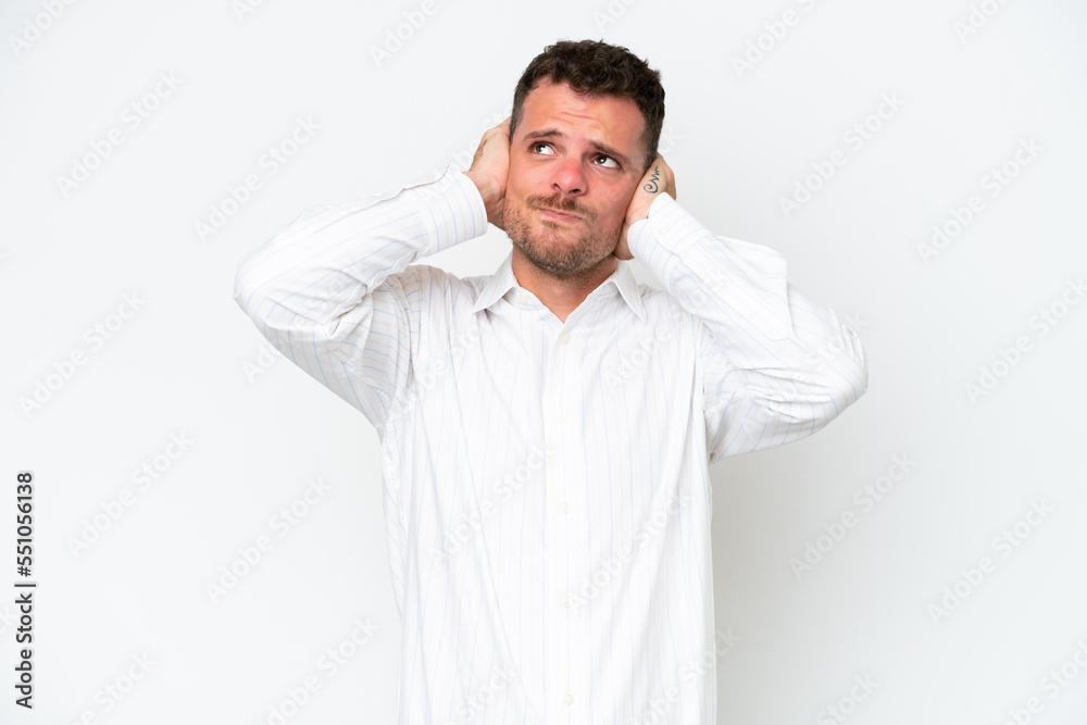 Fototapeta premium Young caucasian handsome man isolated on white background frustrated and covering ears