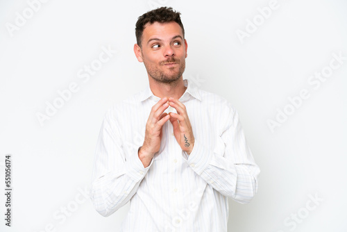 Young caucasian handsome man isolated on white background scheming something