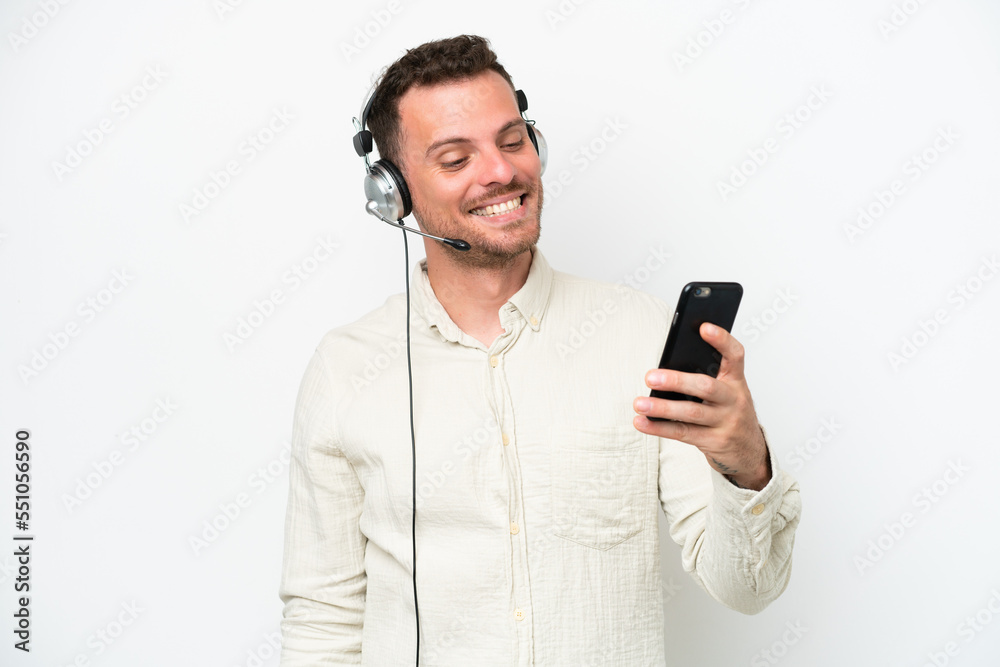 Telemarketer caucasian man working with a headset isolated on white background making a selfie Telemarketer caucasian man working with a headset isolated on white background making a selfie