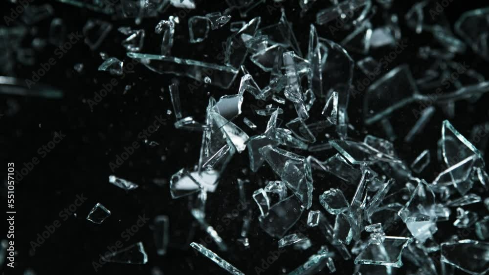 Super Slow Motion Shot of Glass Shards Flying Towards Camera Isolated on Black at 1000fps. Super Slow Motion Shot of Glass Shards Flying Towards Camera Isolated on Black at 1000fps.