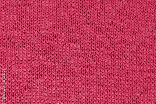 Knitted fabrics. Viva Magenta trendy color 2023 knitted background in red jersey.