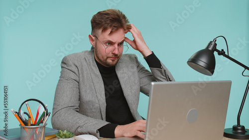 Fotografie Sad business man sitting at office feeling hopelessness loneliness, nervous breakdown, loses, depression, crisis, bankruptcy, depression, bad fortune, loss, unlucky news