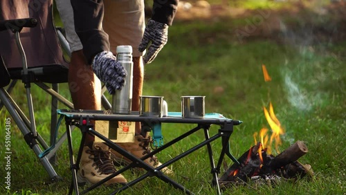 Senior men on holiday activities by camping outside