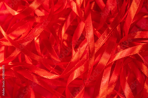 Romantic scarlet background from a red silk ribbon. Abstract background for Valentine's Day, weddings and celebrations.