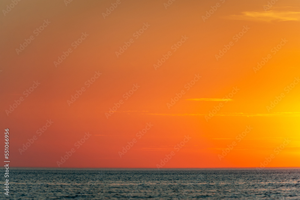 Beautiful view of orange sunset seascape. Ruhnu, Estonia. Tropical colorful sea landscape.